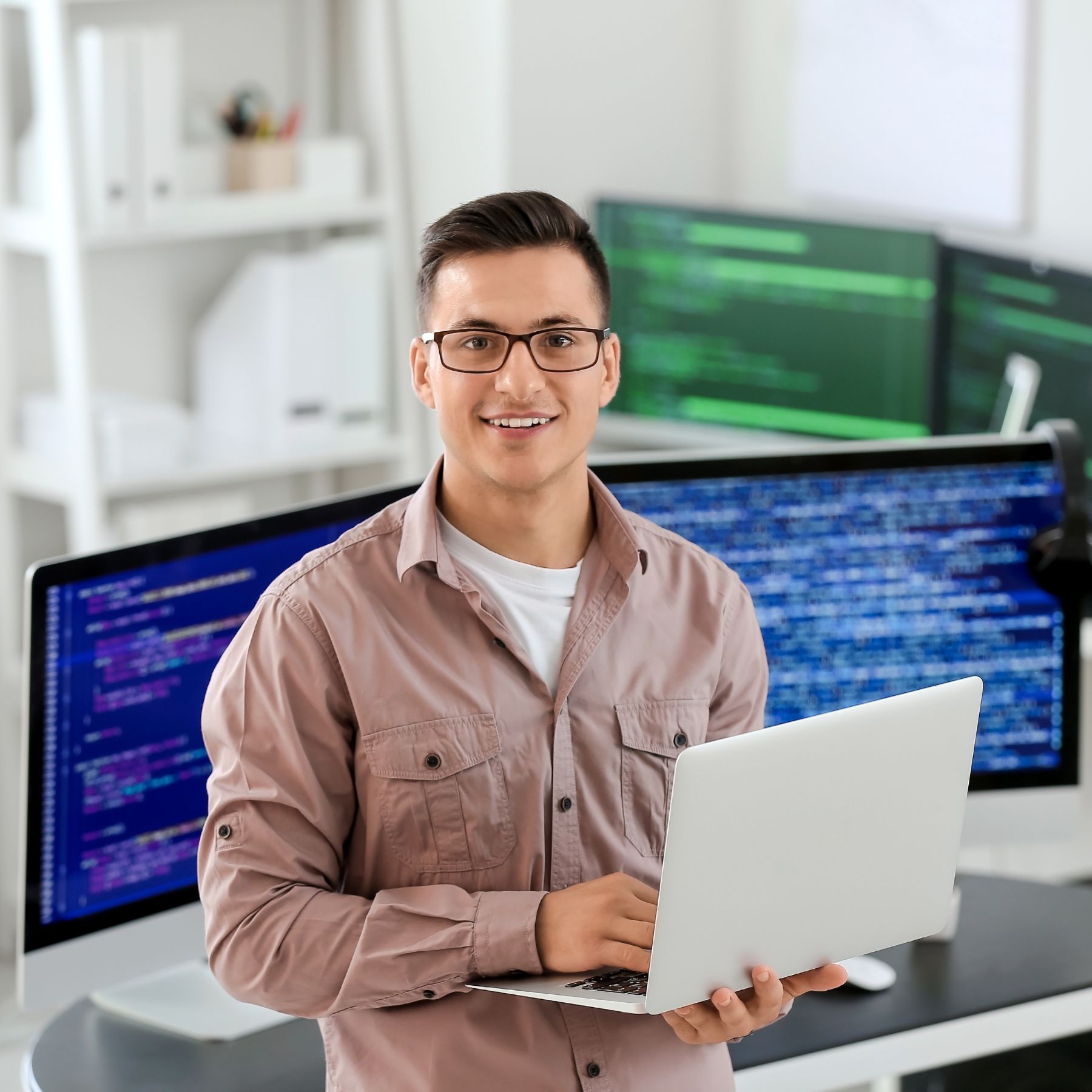 Software engineer holding computer